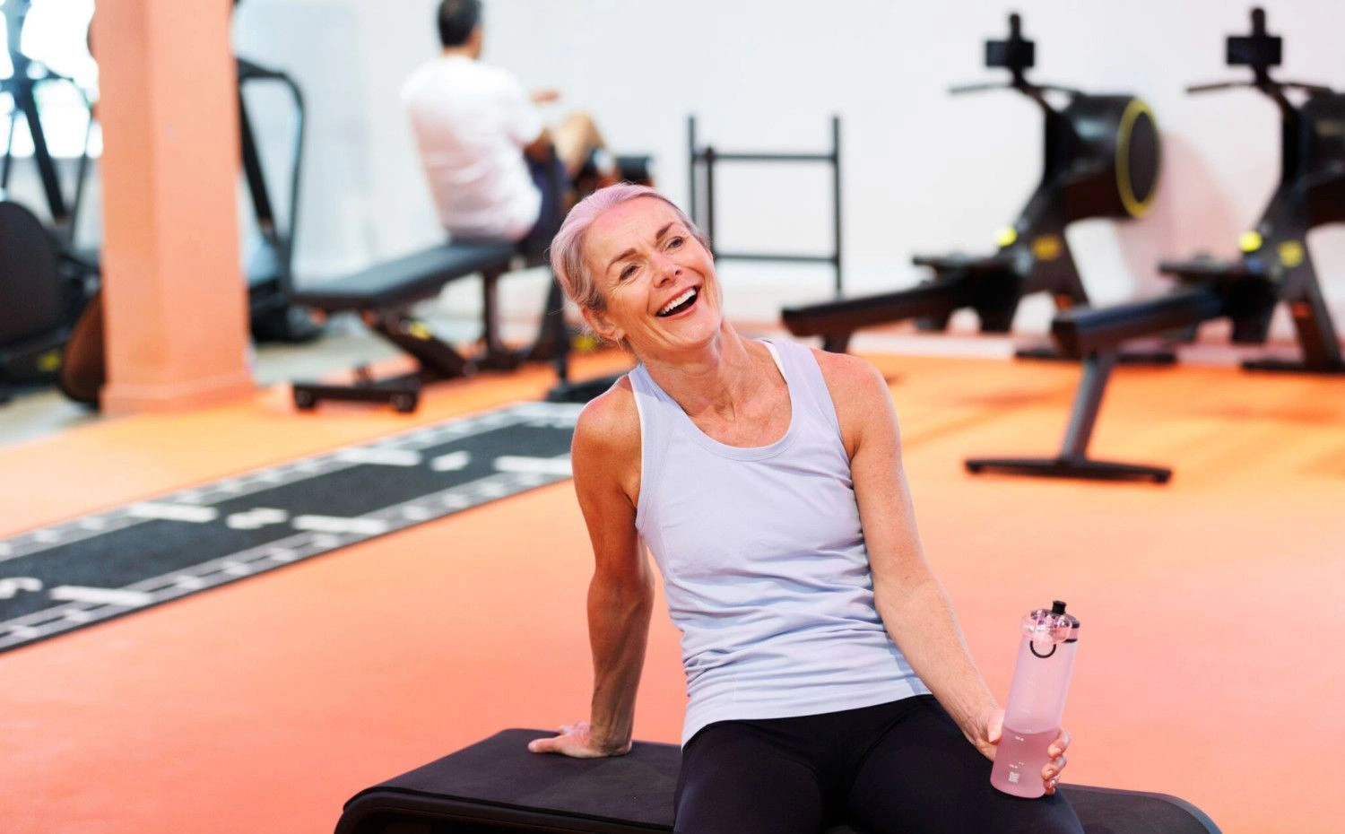 lady in gym holding a water bottle