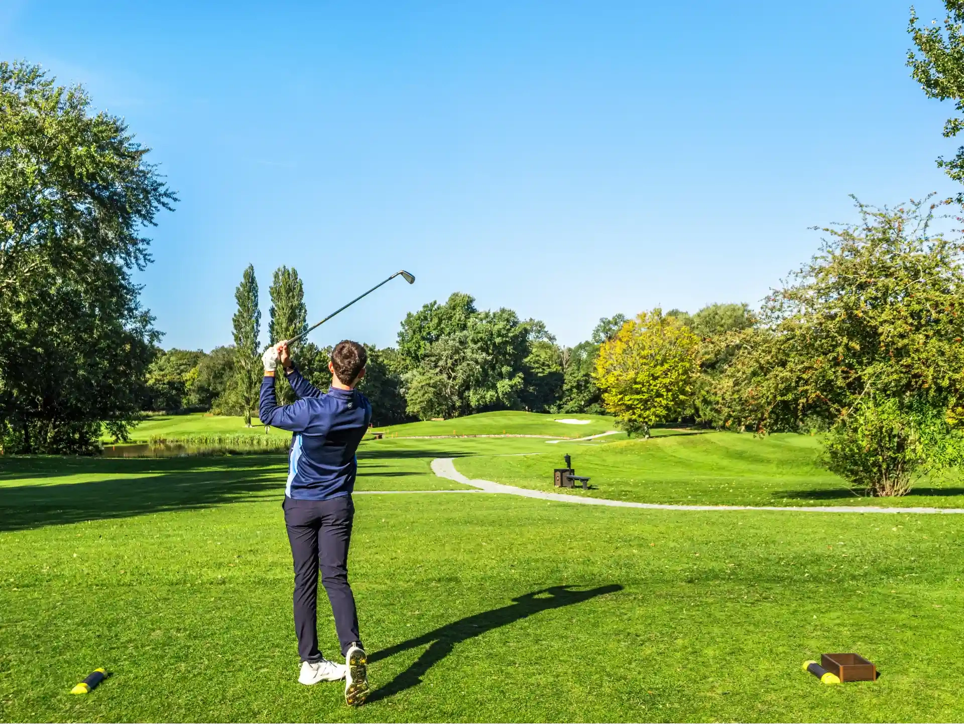 man swinging golf club