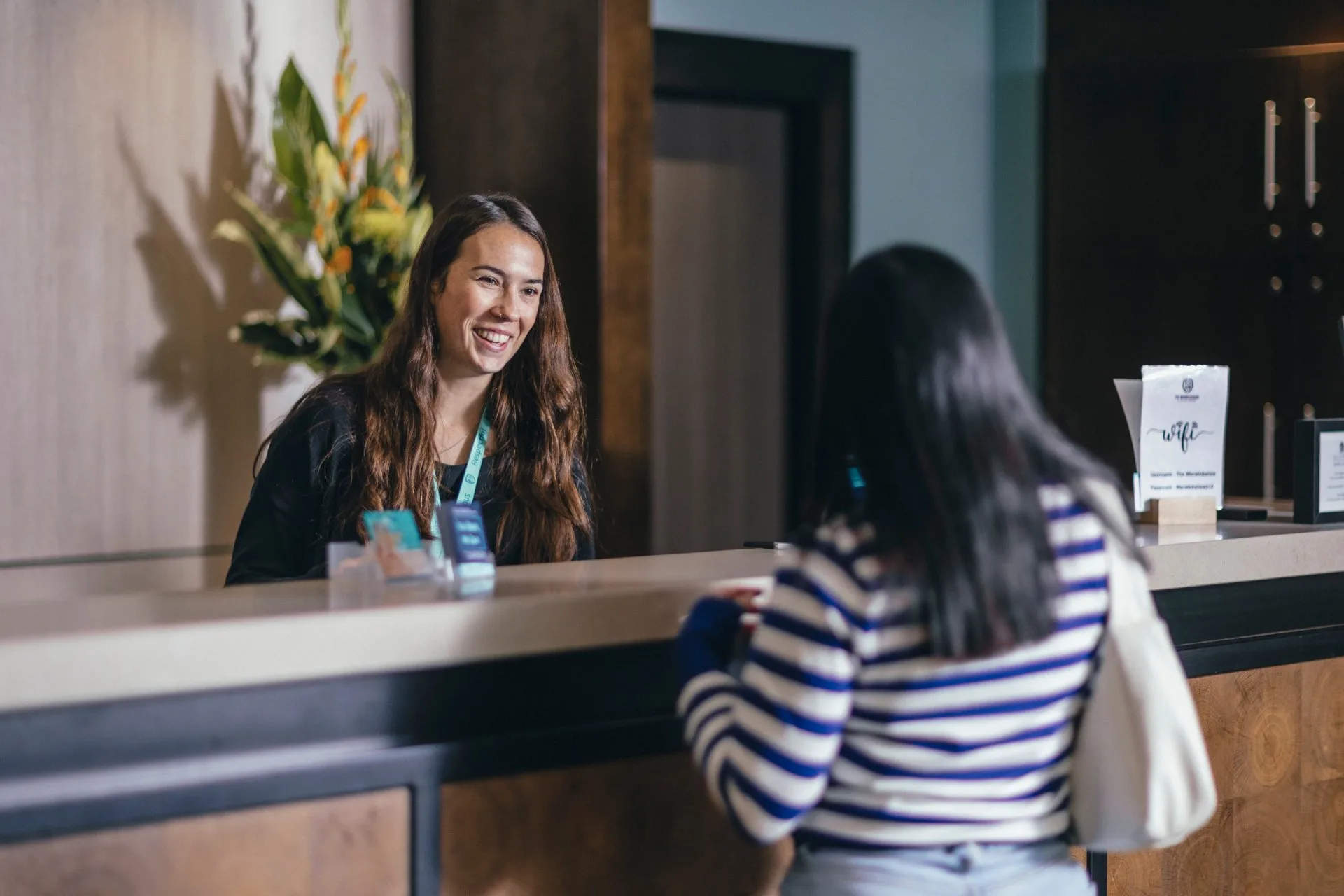 receptionist helping female member
