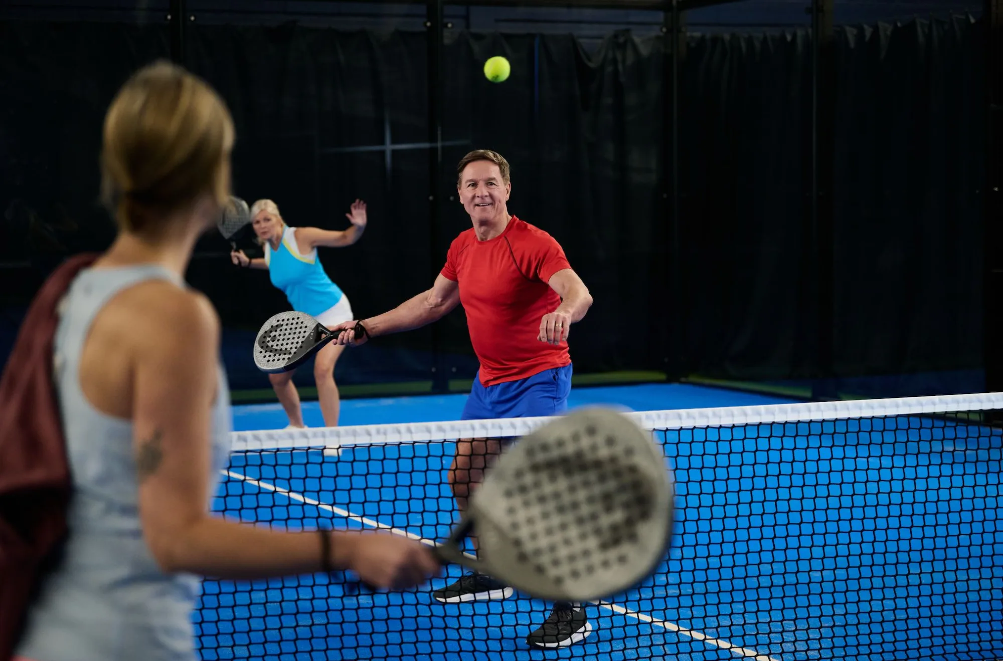man going to hit ball playing padel